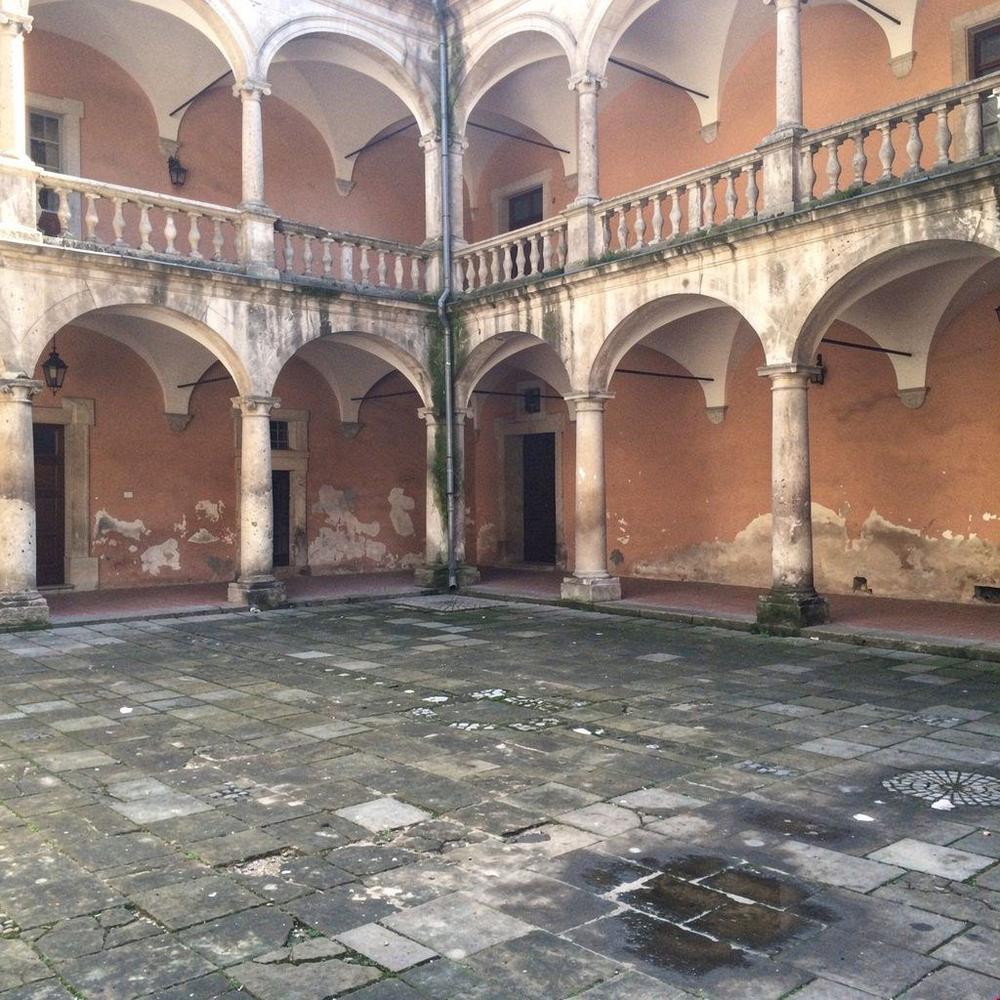Arcaded Renaissance courtyard of a townhouse on Rynok Square in Lviv, seen from the first-floor gallery.